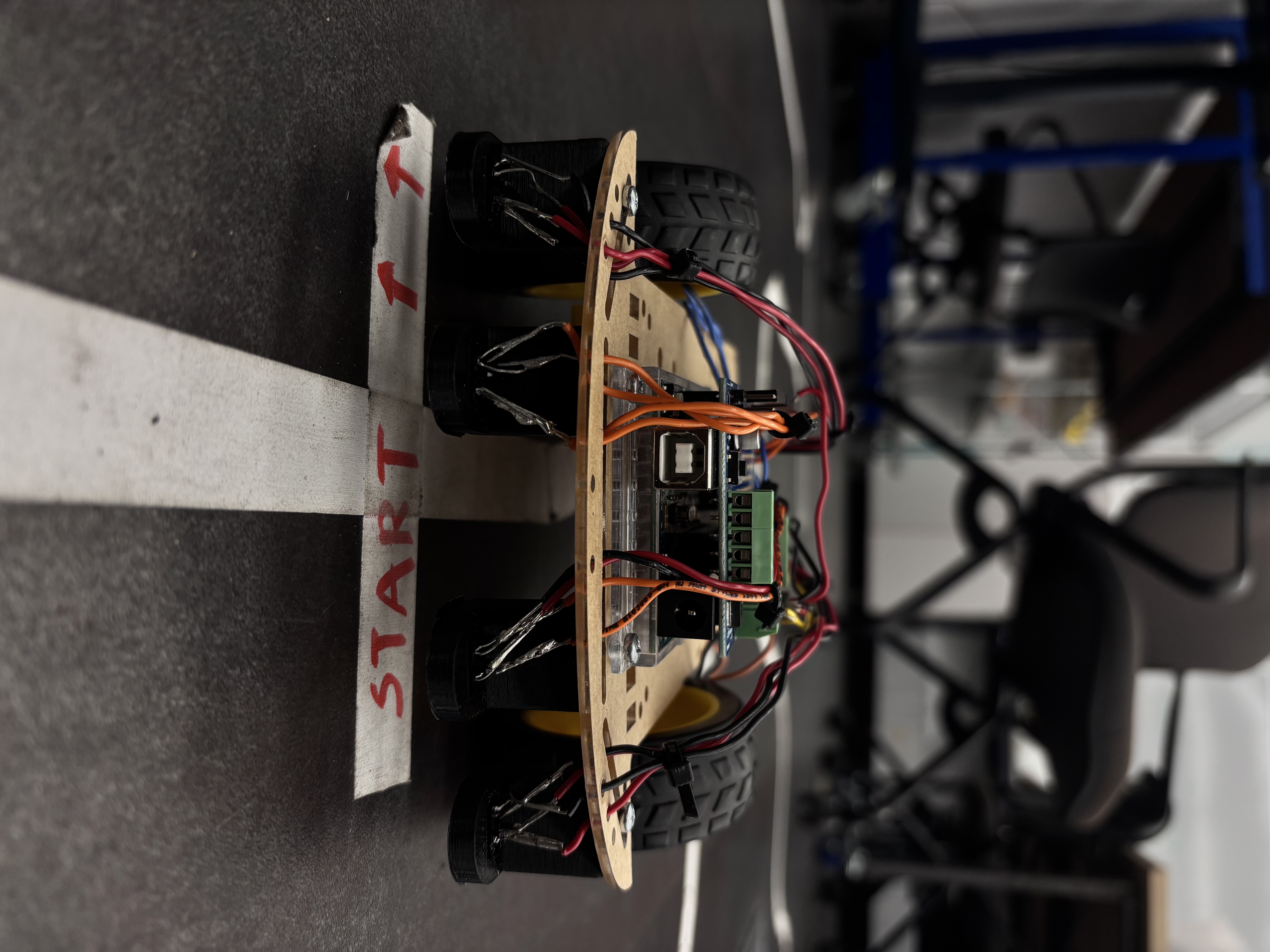 Front view of the line-sensing robot showing the four IR sensor array and motor shield