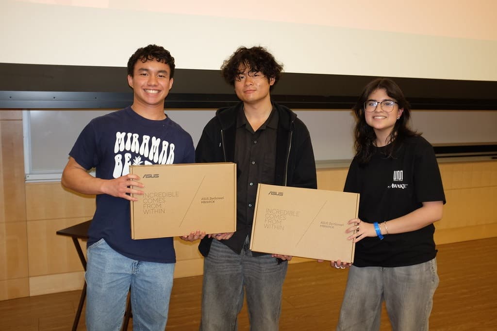 Canary team members holding ASUS ZenScreen prizes at the YHack awards ceremony