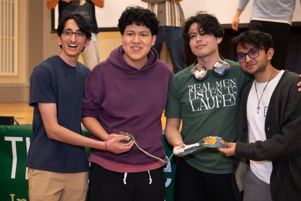 The Gait AI team holding the prototype insole and ESP32 enclosure after winning the buildathon